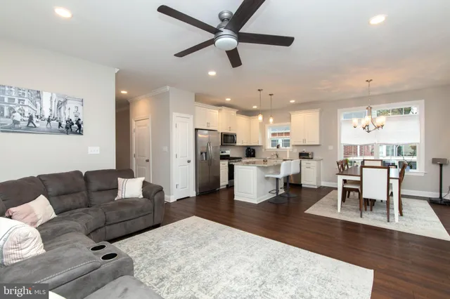 a living room with furniture kitchen view and a dining table