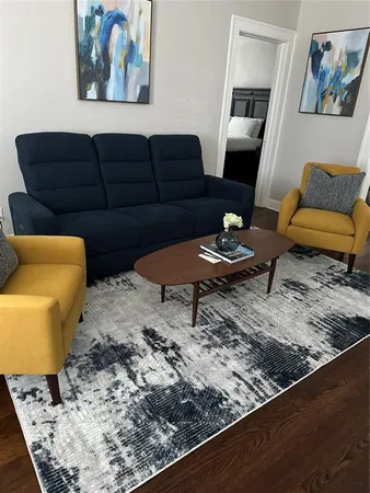 a living room with furniture and a rug