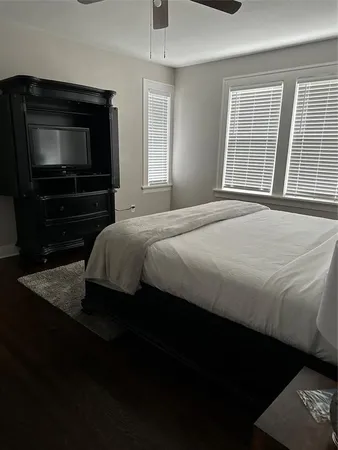 a bedroom with a bed and a television