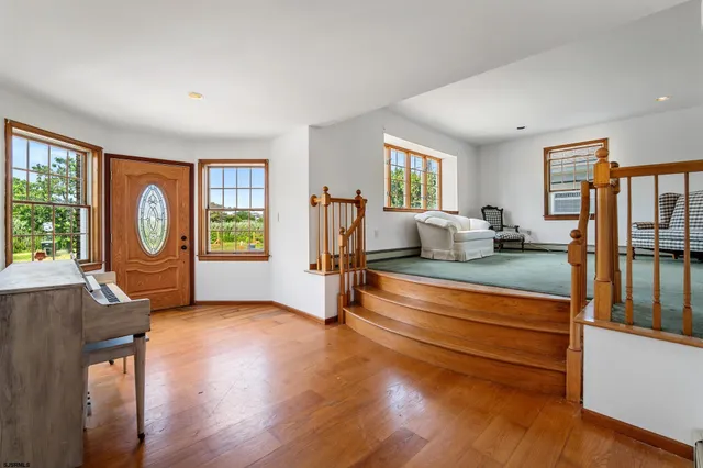 a living room with fireplace furniture and a window