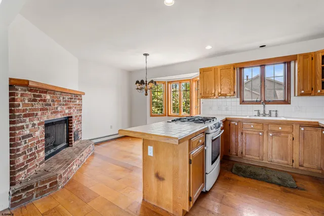 a kitchen with a stove top oven sink and a window