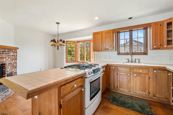 a kitchen with a stove a sink dishwasher and a refrigerator