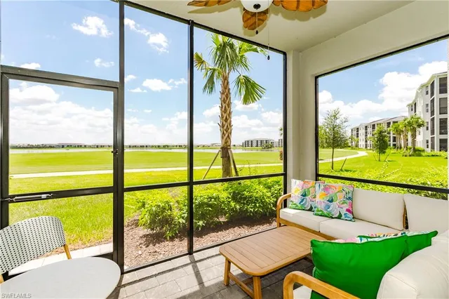 a room with pool table and chairs