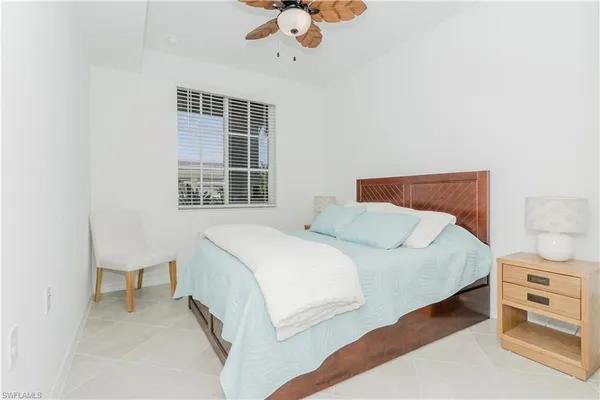 a bedroom with a bed and a chair