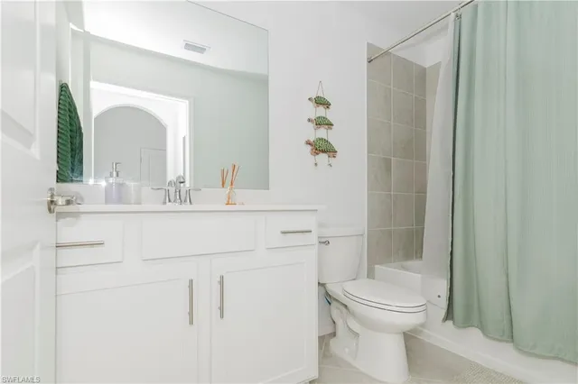 a bathroom with a sink vanity mirror and toilet