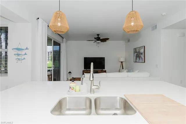 a kitchen with a sink and a refrigerator