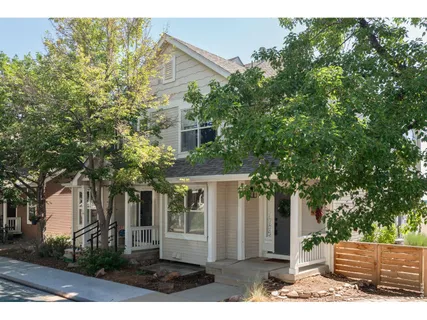 a front view of a house with a yard and potted plants
