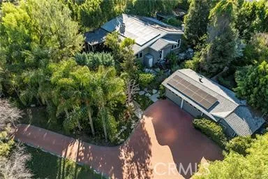 an aerial view of a house with a yard and garden