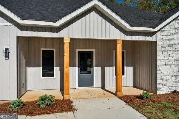 a front view of a house with garden