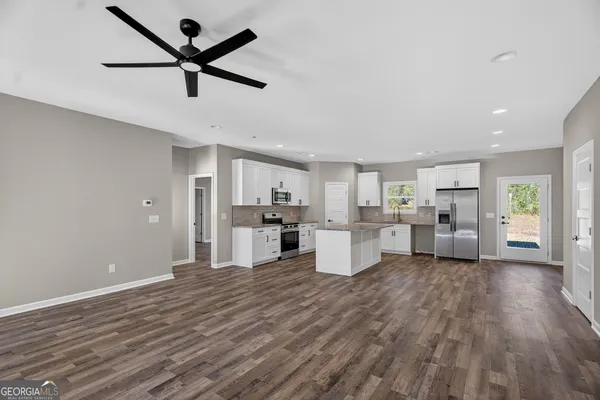 a view of a kitchen with microwave and refrigerator