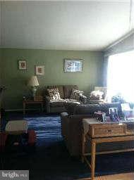 8514 Stevenswood Road Baltimore, MD 21244 - Photo 7 of 15 a room with a table chairs and wooden floor