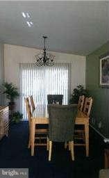 8514 Stevenswood Road Baltimore, MD 21244 - Photo 8 of 15 a view of a dining room with furniture and chandelier