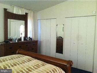 8514 Stevenswood Road Baltimore, MD 21244 - Photo 9 of 15 a bedroom with a bed and a mirror