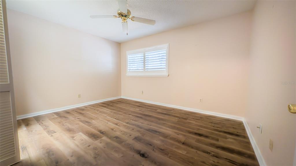 9357 Southwest 82nd Terrace, Unit C Ocala, FL 34481 - Photo 12 of 30 wooden floor in an empty room