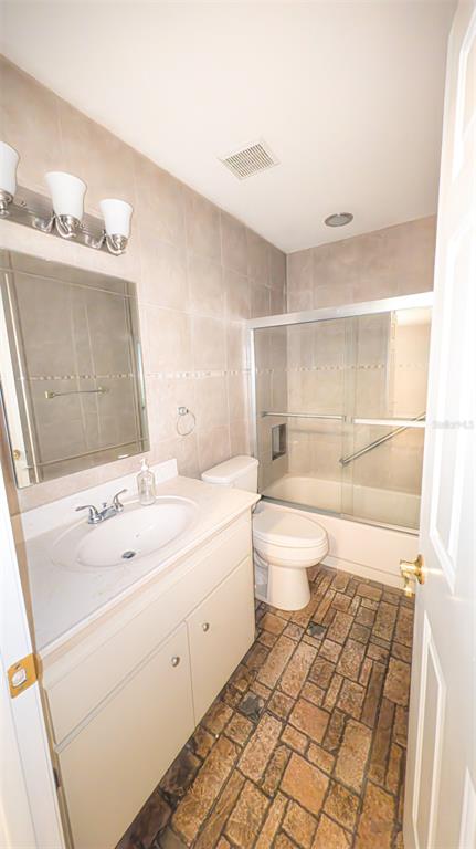 9357 Southwest 82nd Terrace, Unit C Ocala, FL 34481 - Photo 20 of 30 a bathroom with a sink a toilet and shower