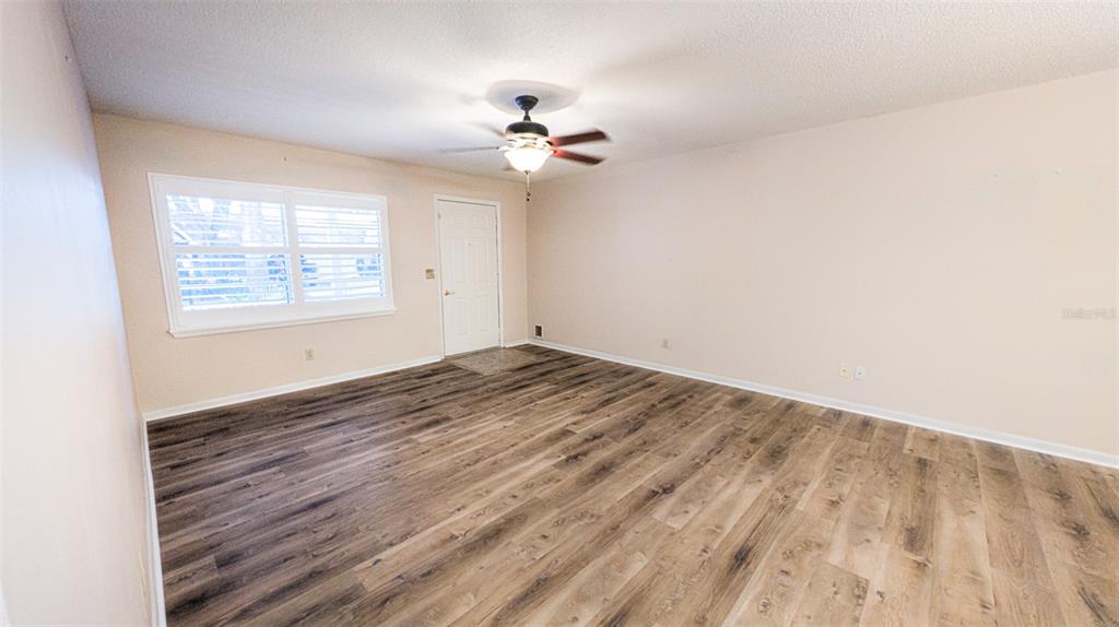 9357 Southwest 82nd Terrace, Unit C Ocala, FL 34481 - Photo 22 of 30 wooden floor in an empty room with a window