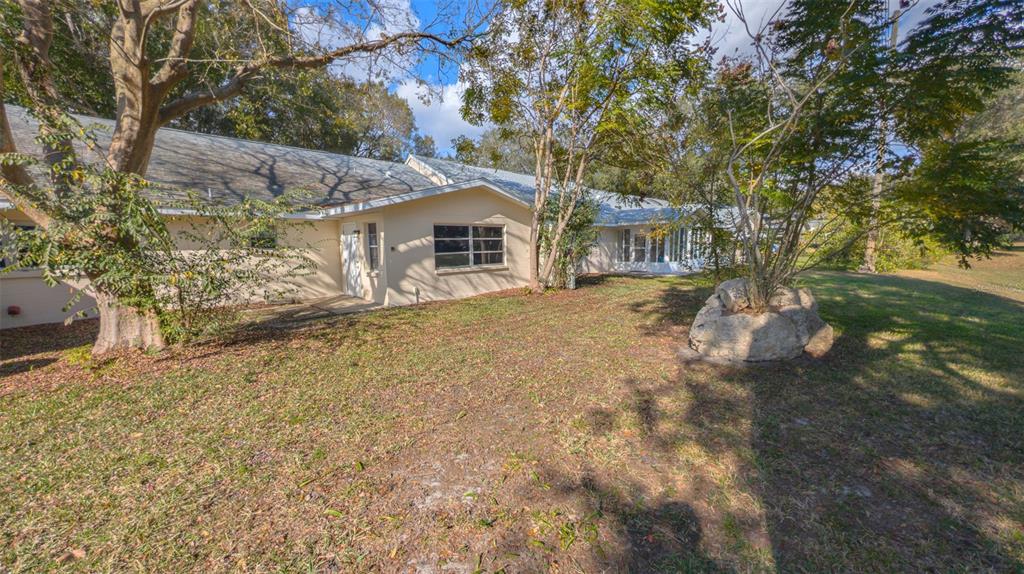 9357 Southwest 82nd Terrace, Unit C Ocala, FL 34481 - Photo 27 of 30 a front view of a house with large trees