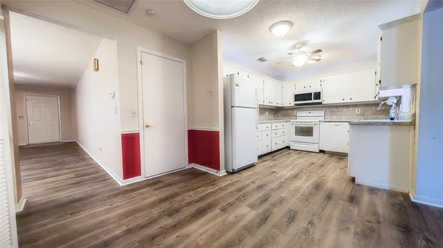 a kitchen with granite countertop a sink and cabinets