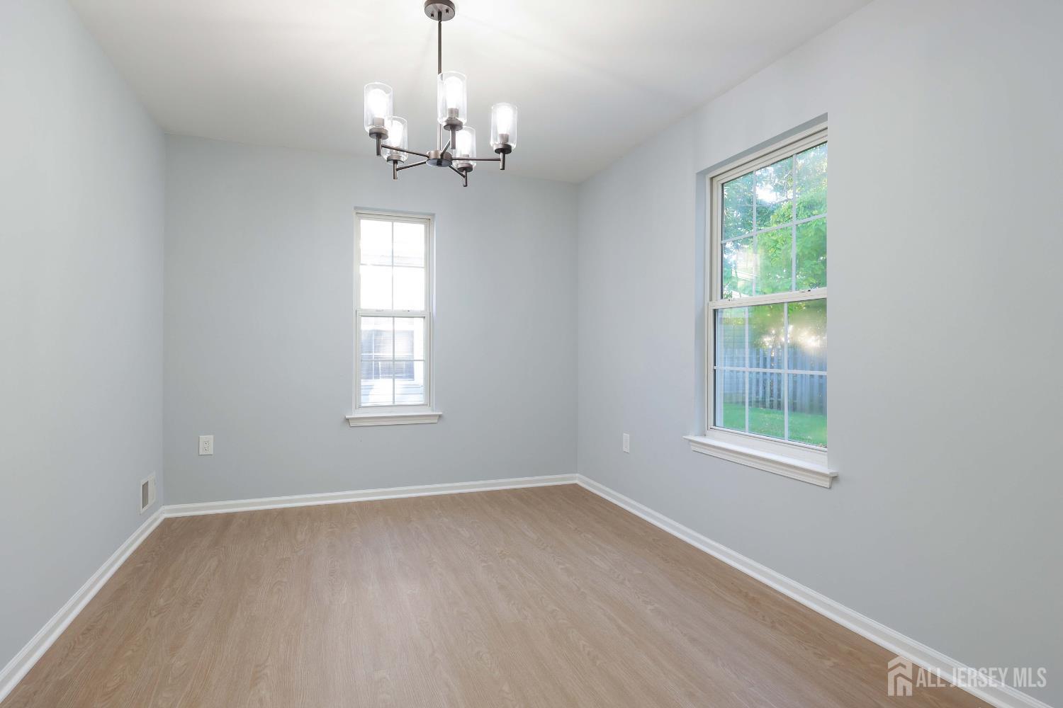 4 Ellison Court Keyport, NJ 07735 - Photo 18 of 37 a view of empty room with wooden floor and chandelier