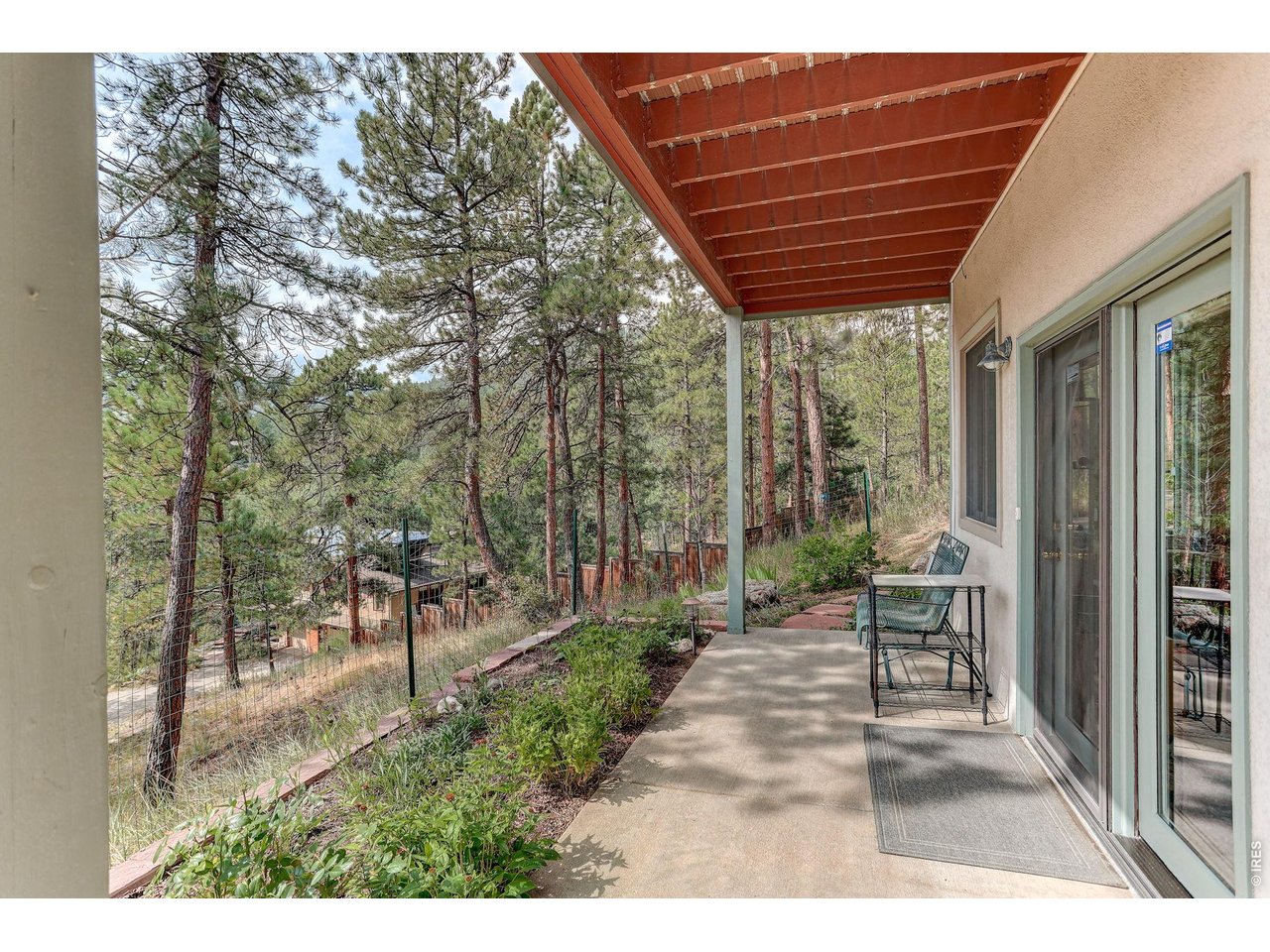65 Betasso Road Boulder, CO 80302 - Photo 36 of 38 a view of a patio with table and chairs with wooden floor and fence