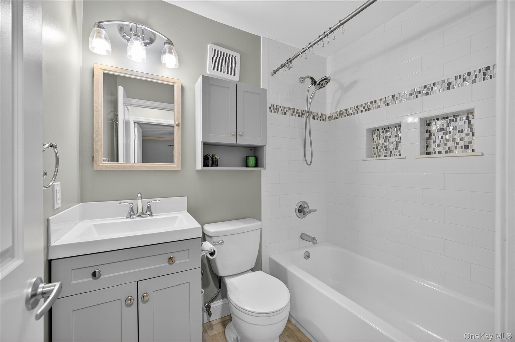 10 Secora Road, Unit L12 Monsey, NY 10952 - Photo 9 of 24 a bathroom with a sink a toilet and a mirror