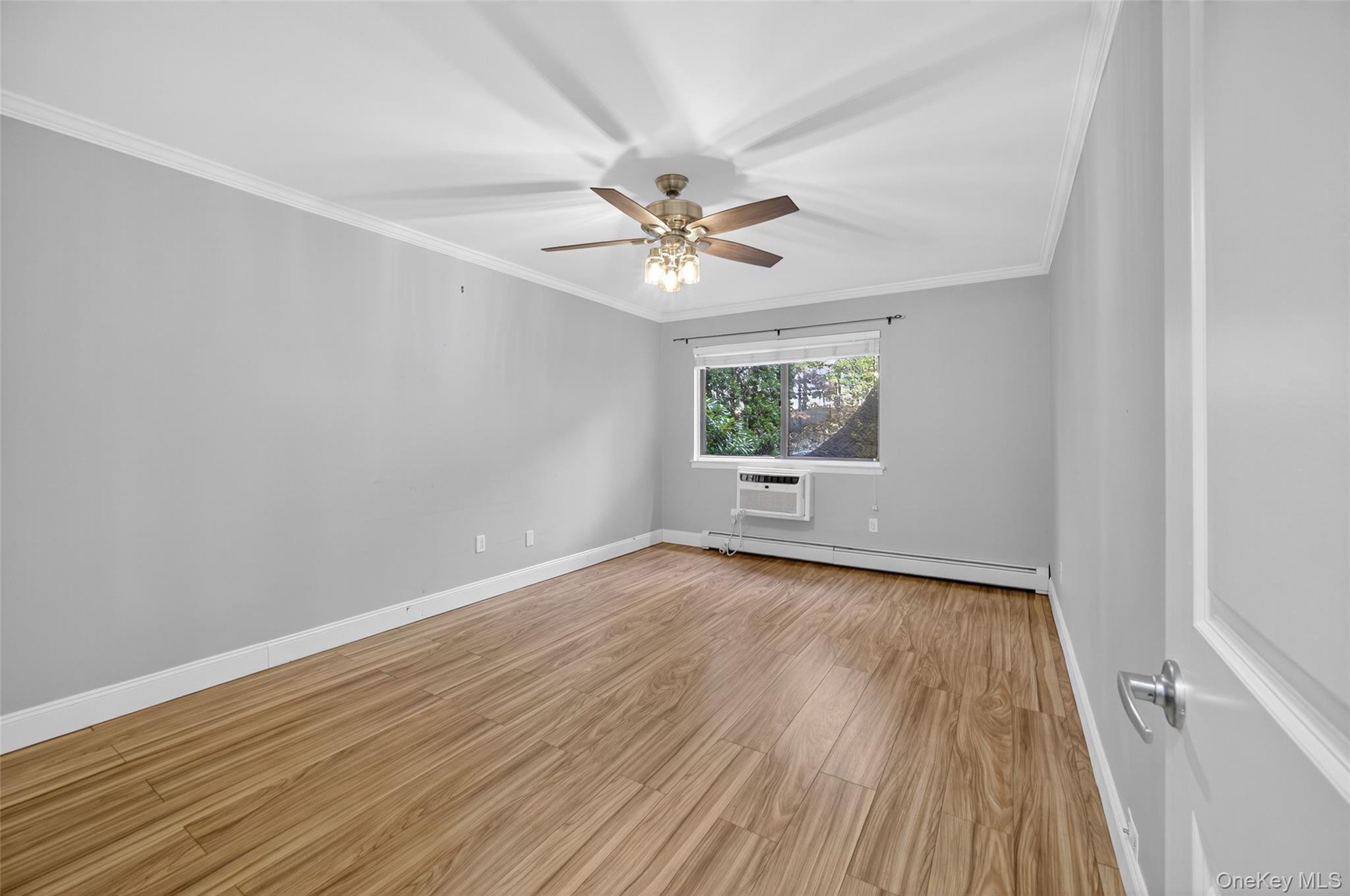 10 Secora Road, Unit L12 Monsey, NY 10952 - Photo 11 of 24 wooden floor in an empty room with a window