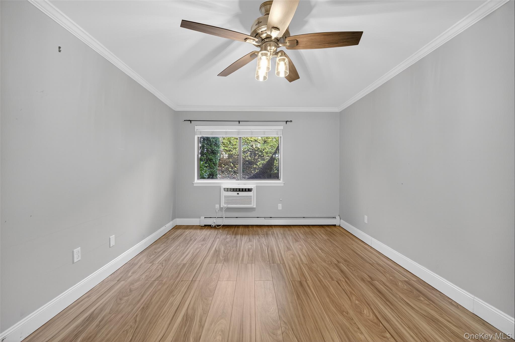 10 Secora Road, Unit L12 Monsey, NY 10952 - Photo 12 of 24 wooden floor in an empty room with a window