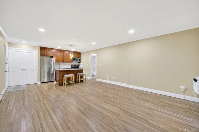 a view of kitchen with furniture and wooden floor