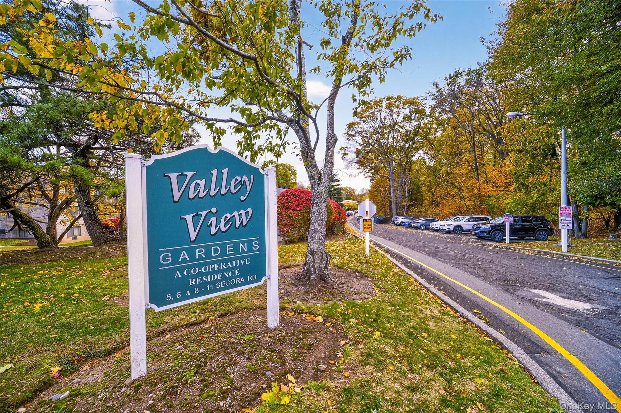 10 Secora Road, Unit L12 Monsey, NY 10952 - Photo 21 of 24 a sign board with a yard