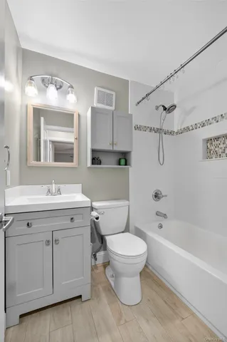 a kitchen with granite countertop stainless steel appliances a sink stove and refrigerator