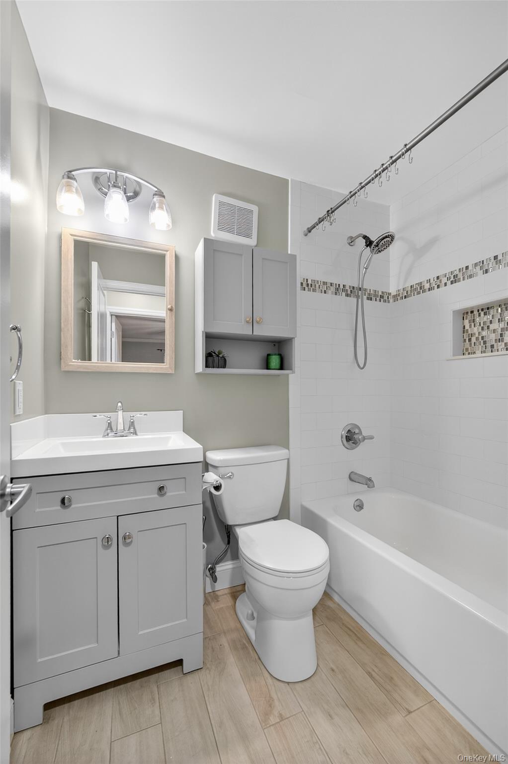 10 Secora Road, Unit L12 Monsey, NY 10952 - Photo 8 of 24 a bathroom with a sink toilet a mirror and bathtub