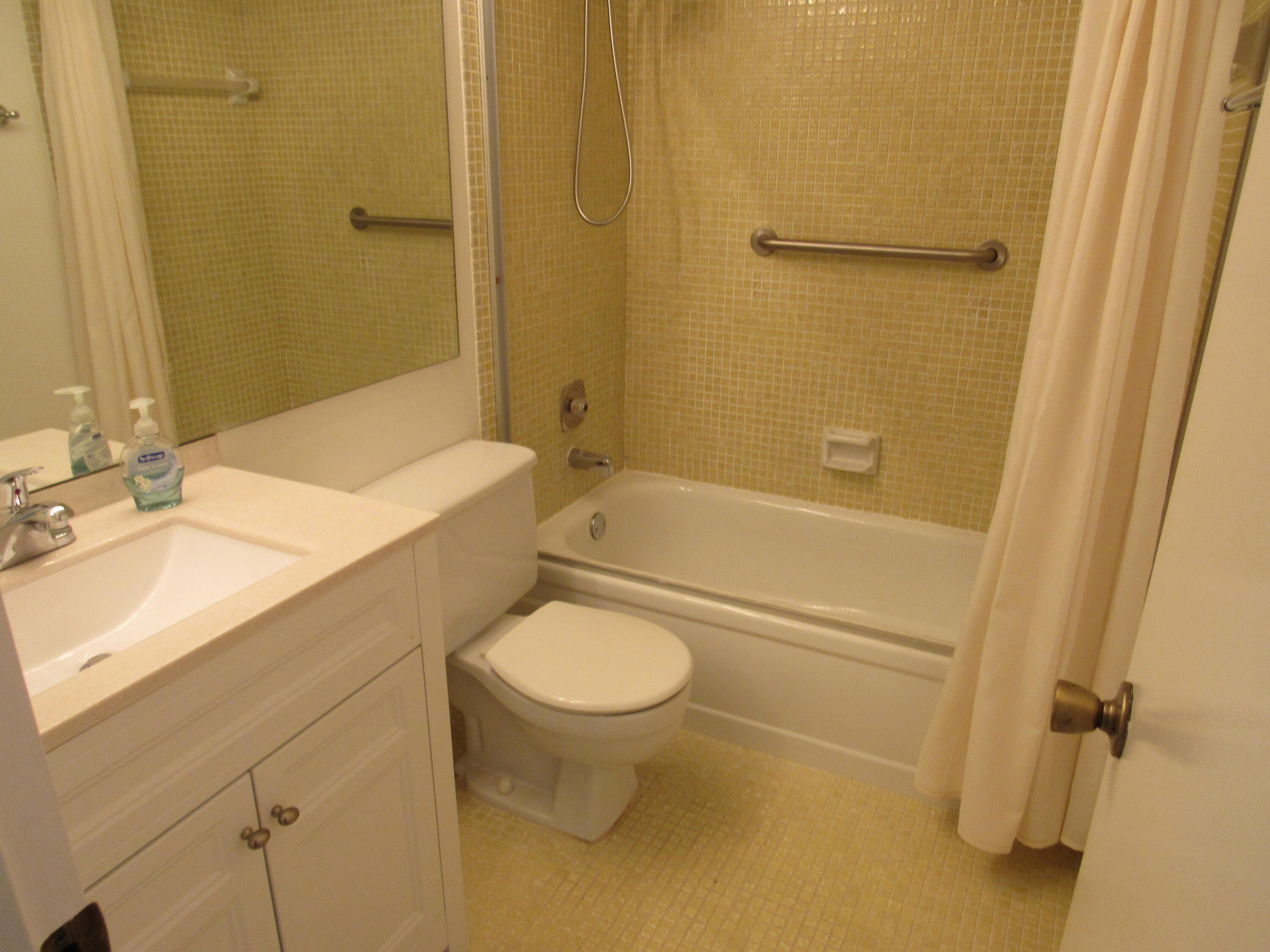 310 Brighton H Boca Raton, FL 33434 - Photo 15 of 41 a bathroom with a granite countertop sink toilet and shower