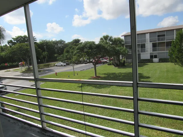 a view of a wooden deck with a big yard