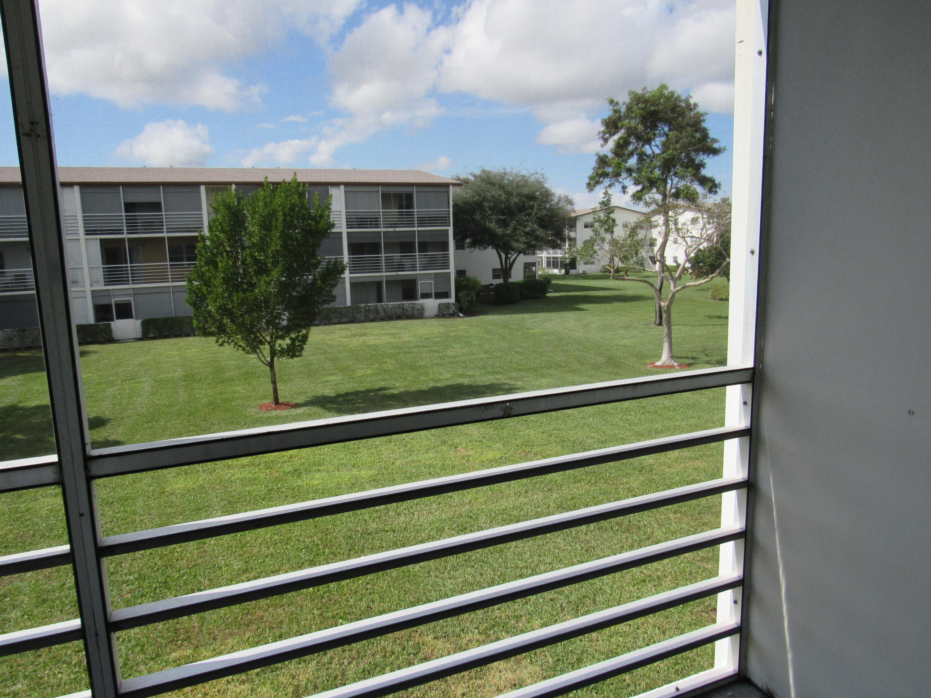 310 Brighton H Boca Raton, FL 33434 - Photo 26 of 41 a view of a house with a backyard and a garden