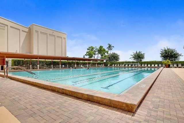 a view of a swimming pool with a yard