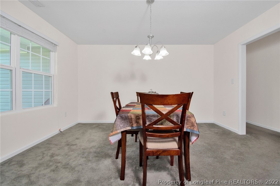 166 Hayden Road Fairmont, NC 28340 - Photo 7 of 37 a view of a dining room with furniture and chandelier