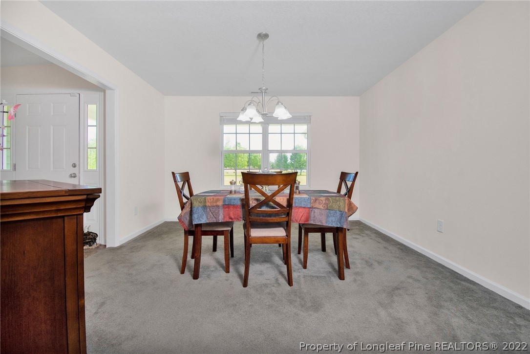 166 Hayden Road Fairmont, NC 28340 - Photo 8 of 37 a view of a dining room with furniture and chandelier