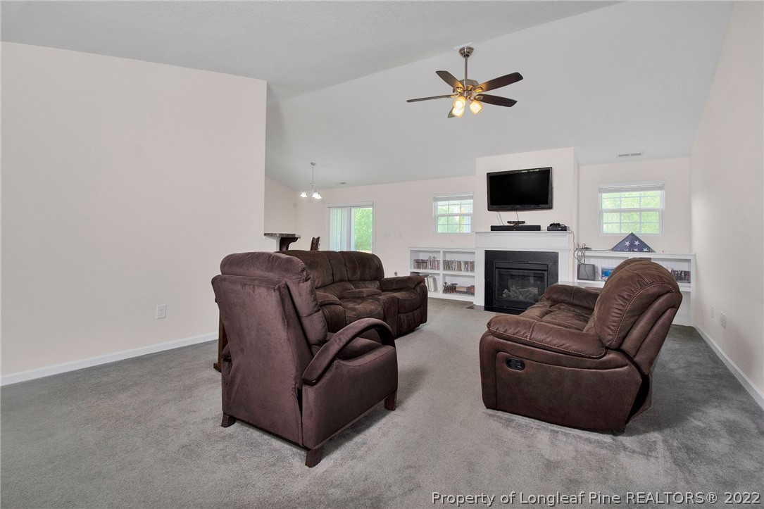 166 Hayden Road Fairmont, NC 28340 - Photo 9 of 37 a living room with furniture a fireplace and a flat screen tv