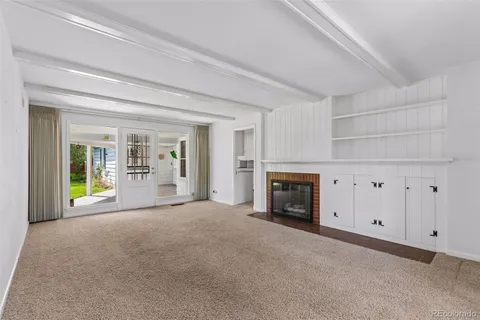 a view of a livingroom with an empty space and a fireplace