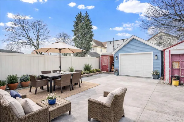 a view of a house with backyard and sitting area