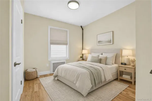 a bedroom with a bed and a painting on the wall
