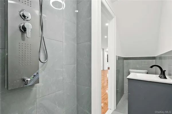 a bathroom with a shower sink and mirror