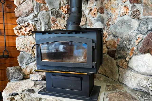 a living room with a fireplace and a stove