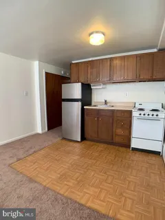 a kitchen with a cabinets a refrigerator and a sink
