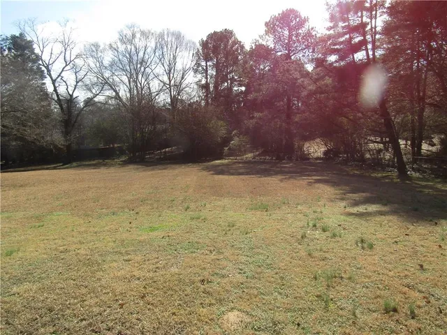 a view of a yard with a house in the background