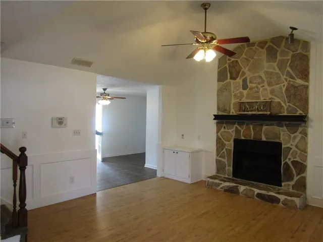 a view of a livingroom with a fireplace and window