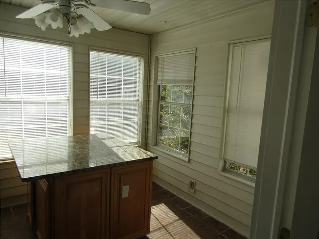 a view of kitchen with granite countertop window and sink