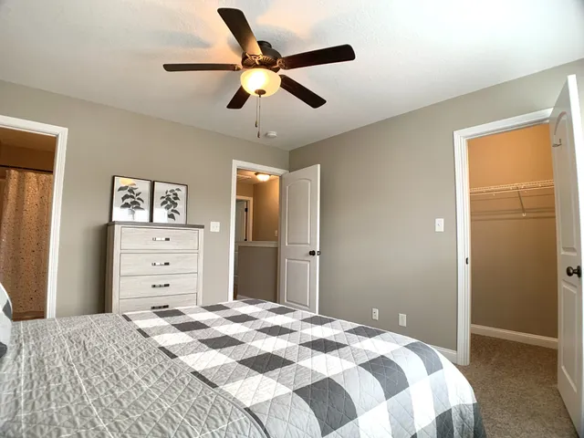 a bedroom with a bed and a chandelier