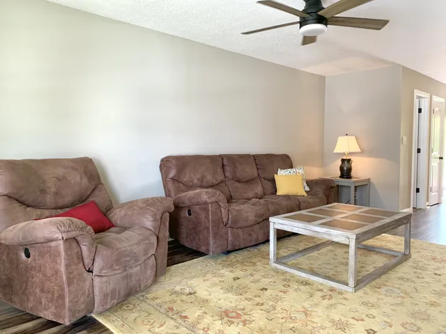 a living room with furniture and a rug