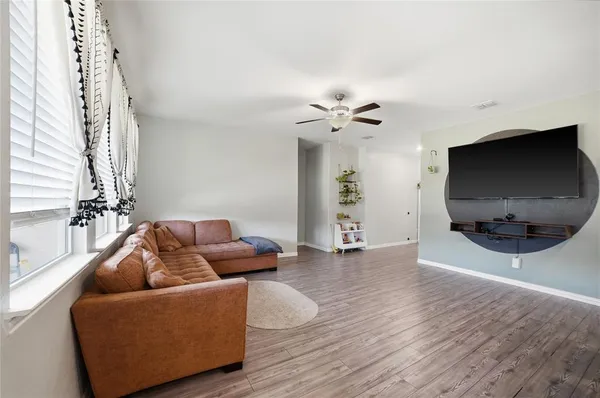 a living room with furniture and a flat screen tv